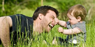 Child and dad playing in the grass © ZoneCreative