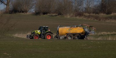 Tractor spraying on farmland