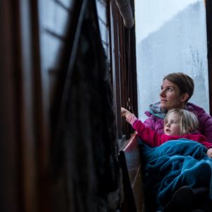 Women and child looking out window