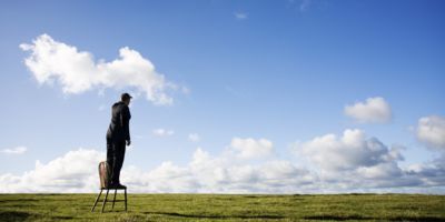 A man standing on a chair for a better view