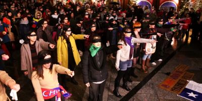 Women demonstrating 'El violador eres tu' in Chile