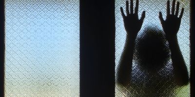 Silhouette behind glass door