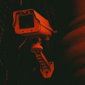 CCTV camera with a red background