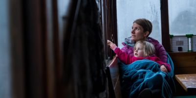 Women and child looking out window