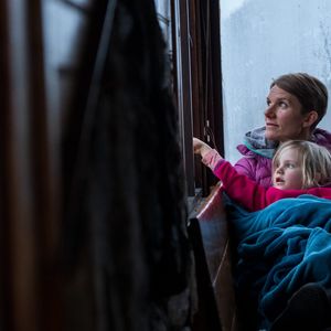 Women and child looking out window