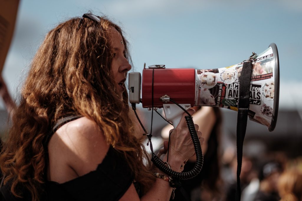 Woman with loud speaker/ CC0 Clem Onojeghuo