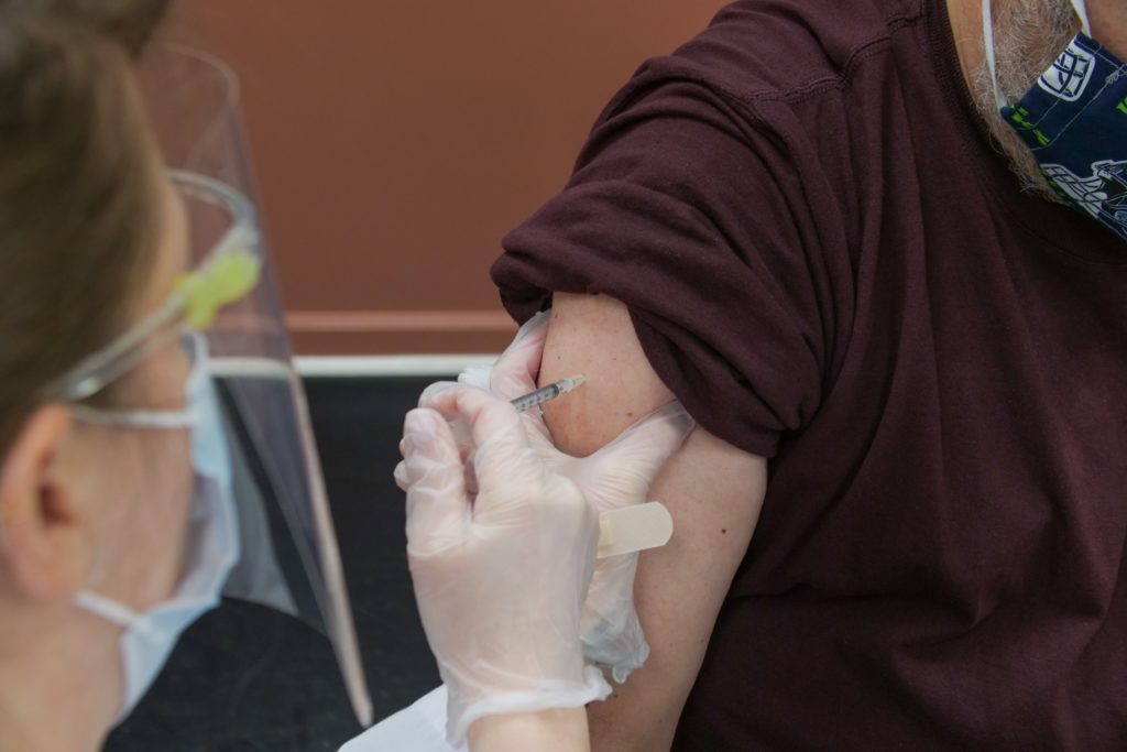 Person receiving a COVID vaccine/ CC0 Steven Cornfield