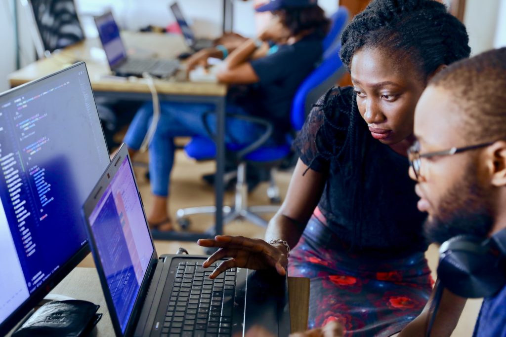 Woman and man working at computer/ CC0 lagos-techie