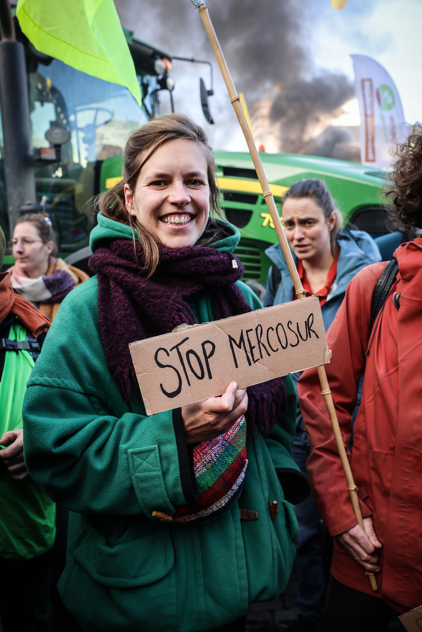 Woman holding a sign saying stop mercosur at a farmers protest 
