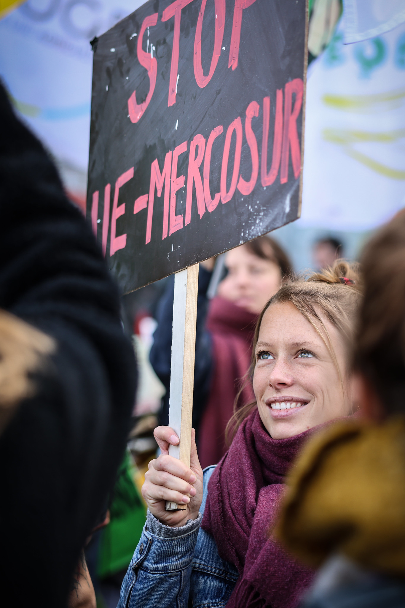 Woman holding a stop mercosur sign at a farmers protest EU-Mercosur